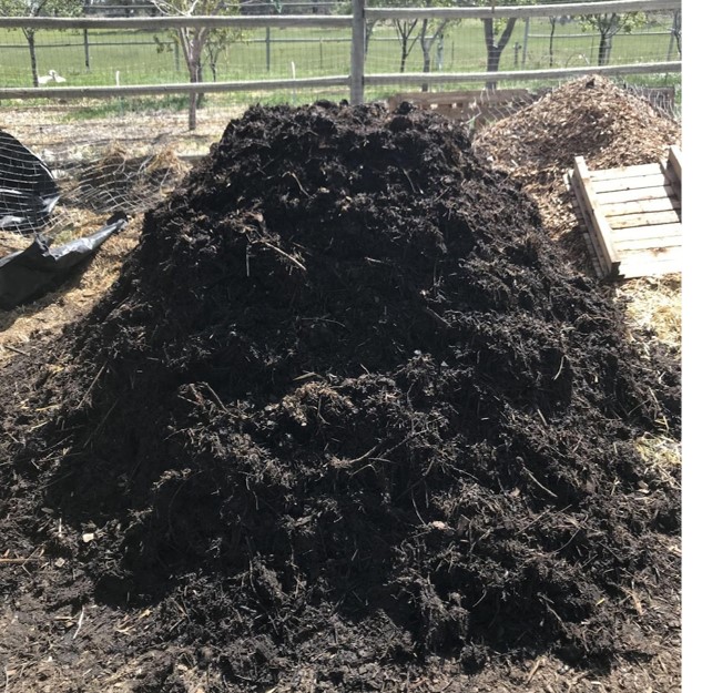 capped compost pile with biochar